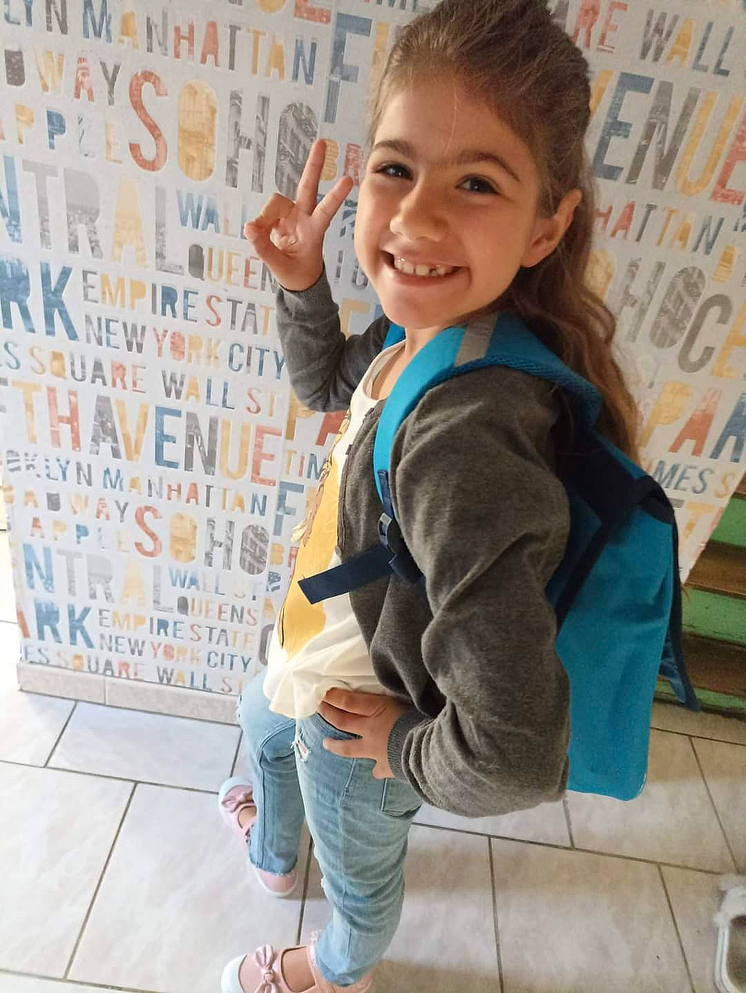 Bella participe au concours pour gagner de l'argent avec cette photo : arm, bag, child, denim, electric_blue, flooring, font, fun, gesture, happy, joint, joy, leisure, person, room, sitting, sleeve, smile, t_shirt, thumb