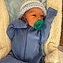 newborn, baby, pacifier, blue_onesie, knitted_hat, blanket, soft_texture, sleepy, infant, cute, cozy, indoor, resting, child, portrait, cute_baby, warm, comfort, toddler, baby_clothing