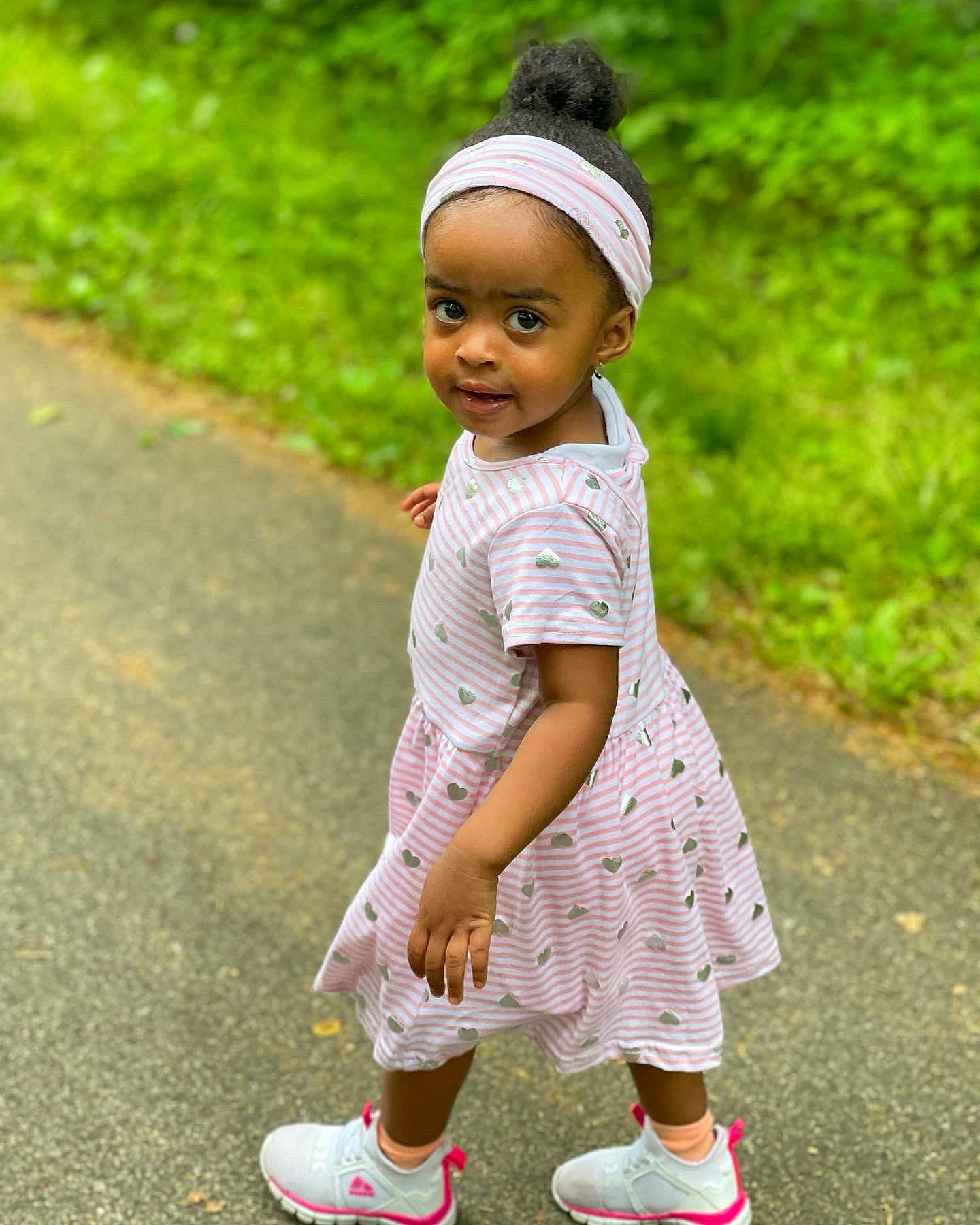 Madeleine is registered to the contest to win money with this photo: baby, baby_toddler_clothing, cap, clothing, cool, face, footwear, grass, happy, people_in_nature, person, pink, plant, shoe, shorts, sleeve, smile, sneakers, sock, street_fashion