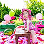 Valentina is registered to the contest to win money with this photo: baby, balloons, birthday, blanket, celebration, child, colorful, cute, food, grass, green, hat, nature, outdoor, party, picnic, pink, summer, table, watermelon