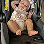 Valentina is registered to the contest to win money with this photo: baby, infant, car_seat, pink_headband, bow, polka_dot, clothing, cute, child, face, foot, hand, seat, safety, indoor, floor, bracelet, expression, skin, person