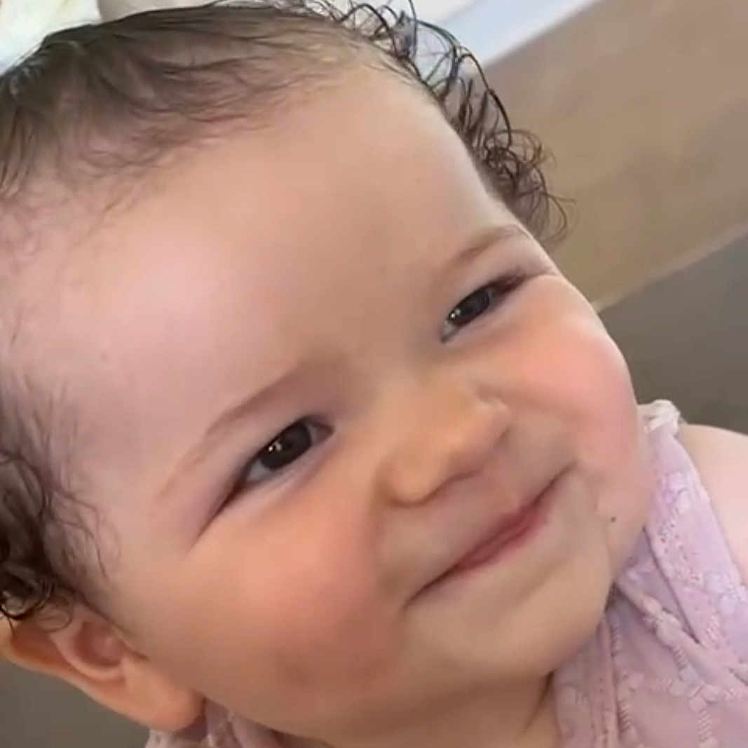 Zariyah Andrea joined the competition — help win amazing prizes! baby, bow, cheeks, child, close_up, curly_hair, cute, eyebrows, eyes, face, happy, head, indoor, infant, mouth, person, pink_dress, portrait, skin, smile