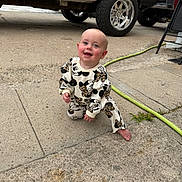 Oakley is registered to the contest to win money with this photo: baby, child, smiling, crouching, outdoor, concrete, truck, vehicle, hose, barefoot, clothing, cute, happy, person, face, head, playful, infant, daylight, casual