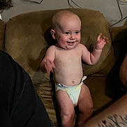 Oakley joined the competition — help win amazing prizes! baby, diaper, couch, smiling, happy, infant, tattoo, arm, person, indoor, furniture, skin, hand, face, expression, candid, family, seated, brown, wires