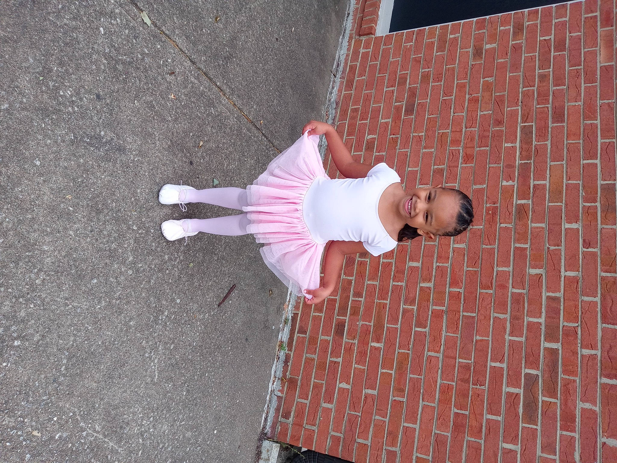 Arie is registered to the contest to win money with this photo: asphalt, brick, brickwork, concrete, door, eyewear, facade, flooring, fun, joy, magenta, pattern, pedestrian, person, road_surface, shadow, sidewalk, street, sunglasses, textile