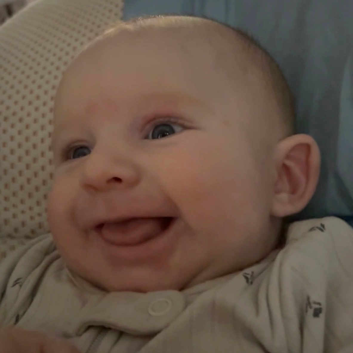 Phoenix Aziel joined the competition — help win amazing prizes! baby, blue_pillow, closeup, clothing, cozy, cute, expression, eyes, face, hand, happy, indoors, infant, lying_down, person, portrait, skin, smile, soft_surface, young_child