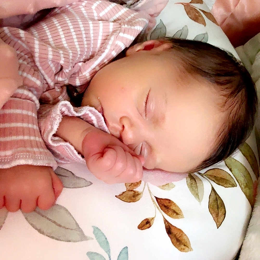 Eliza joined the competition — help win amazing prizes! baby, blanket, child, closeup, comfort, cozy, cute, face, floral_pattern, hand, indoors, infant, newborn, peaceful, pillow, pink, resting, sleeping, soft_texture, striped_clothing