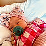 Eliza is registered to the contest to win money with this photo: baby, newborn, pacifier, headband, bow, pink, red, checkered, blanket, bed, sleeping, infant, clothing, cute, face, hand, soft, cozy, resting, indoors