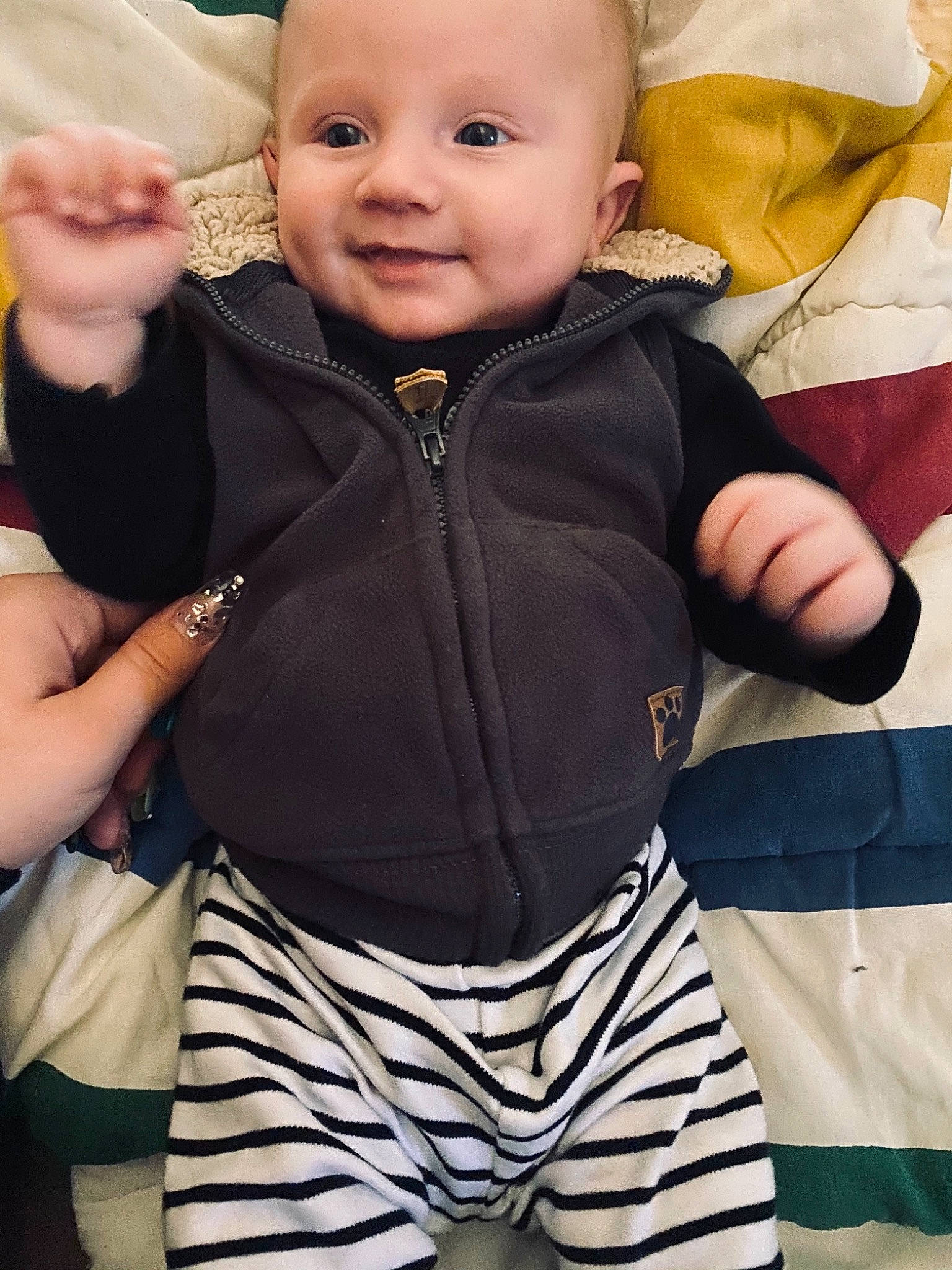 Hayden is registered to the contest to win money with this photo: active_pants, baby, baby_laughing, baby_products, baby_toddler_clothing, cheek, child, cool, finger, gesture, hood, laugh, nail, person, sleeve, sweatpant, thumb, toddler