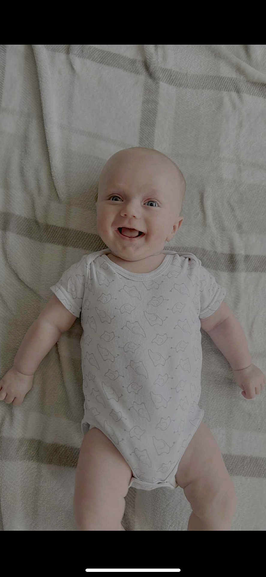 Aiden joined the competition — help win amazing prizes! baby, smiling, infant, onesie, blanket, lying_down, happy, cute, child, face, expression, skin, head, arms, legs, indoors, patterned_clothing, soft_texture, portrait, baby_girl_or_boy