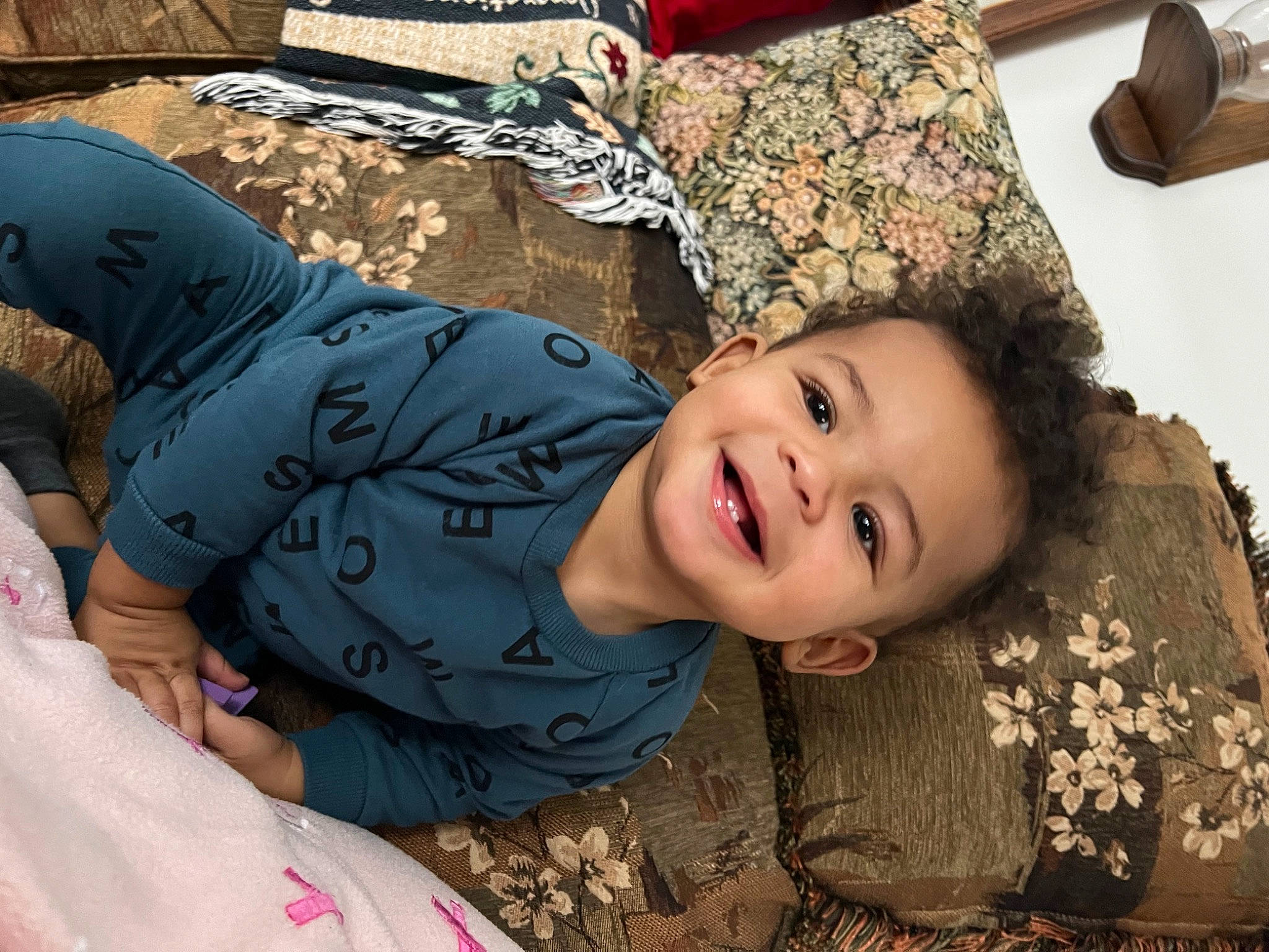 Jadon is registered to the contest to win money with this photo: child, eye, facial_expression, fashion_accessory, flash_photography, fun, grass, happy, head, joy, laugh, leisure, mouth, people_in_nature, person, pink, sitting, smile, toddler, travel