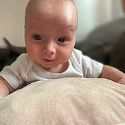 Chase joined the competition — help win amazing prizes! baby, infant, face, blue_eyes, cushion, white_clothing, soft_texture, skin, closeup, portrait, indoor, child, cute, expression, young, head, human, person, curious, baby_girl
