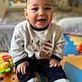 baby, infant, child, smiling, cute, portrait, indoor, playmat, toy, sweater, reindeer_sweater, hands, eyes, chubby_cheeks, sitting, closeup, happy, socks, colorful, soft_toy
