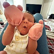 Maryjane joined the competition — help win amazing prizes! baby, infant, mittens, pink, face, expression, cute, clothing, onesie, person, indoor, bedroom, furniture, blanket, legs, lap, window, door, television, home