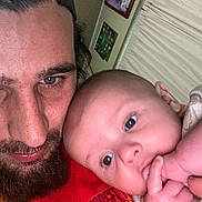 Elias joined the competition — help win amazing prizes! baby, beard, cap, closeup, cuddle, curtains, expression, face, family, hand, headwear, indoor, infant, man, person, photograph, portrait, red_clothing, skin, wall_art