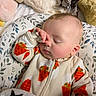 Leo joined the competition — help win amazing prizes! baby, infant, sleeping, peaceful, portrait, face, hand, onesie, clothing, carrot_pattern, blanket, plush_toys, stuffed_animals, bedding, floral_pattern, cozy, indoors, close_up, resting, cute