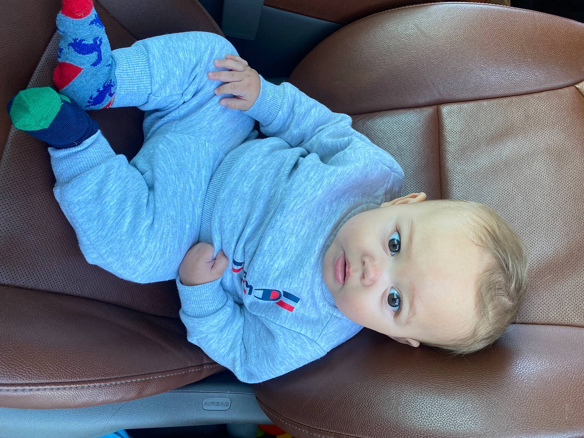 Achilles is registered to the contest to win money with this photo: baby, baby_products, baby_toddler_clothing, blue, comfort, elbow, electric_blue, finger, foot, hand, human_leg, leg, nail, person, plastic_bottle, sleeve, sock, textile, thigh, toddler