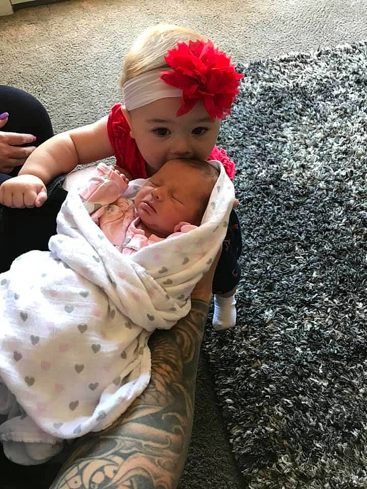 Tristan is registered to the contest to win money with this photo: asphalt, baby, baby_products, baby_toddler_clothing, carmine, cheek, child, comfort, eye, fun, grass, happy, head, headband, headwear, human_leg, lip, person, petal, road_surface