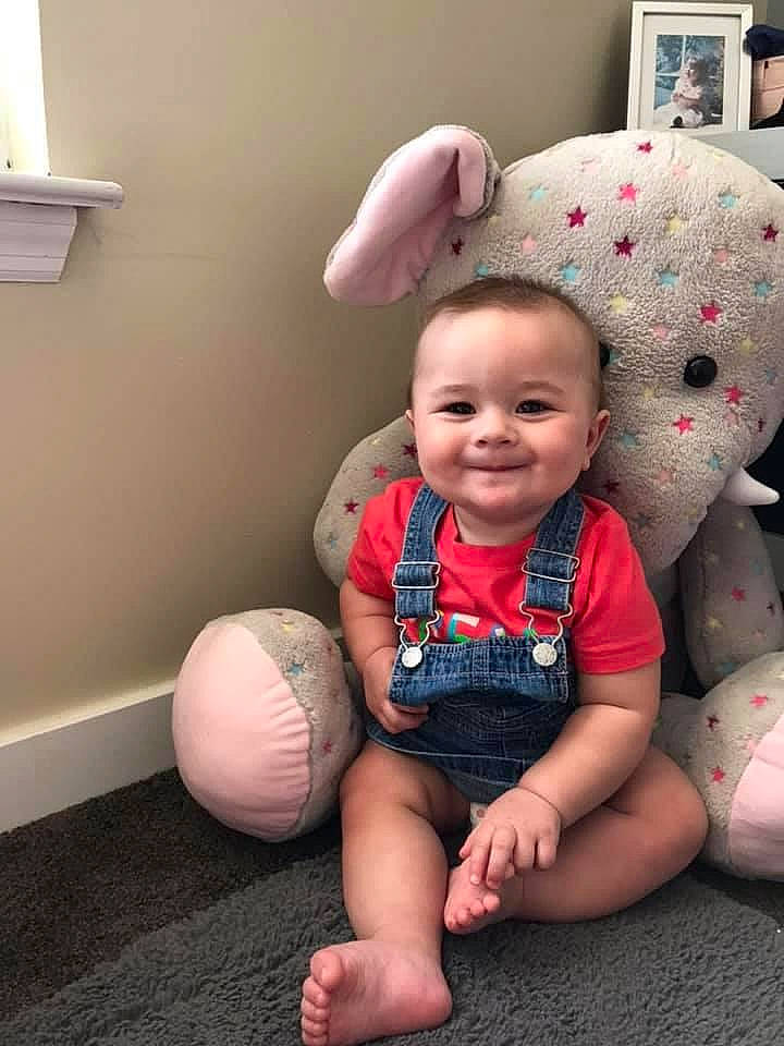 Tristan joined the competition — help win amazing prizes! baby, baby_toddler_clothing, cheek, comfort, eye, facial_expression, finger, floor, flooring, fun, gesture, hairstyle, happy, joy, mouth, person, plant, skin, smile, standing