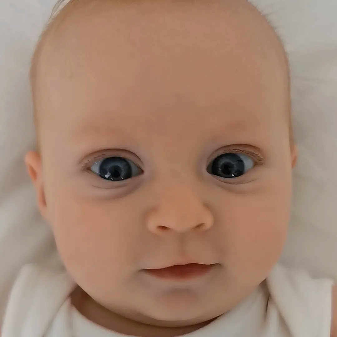 Mia joined the competition — help win amazing prizes! baby, baby_toddler_clothing, cheek, dress, ear, eye, eyebrow, eyelash, face, facial_expression, hairstyle, head, iris, lip, neck, no_expression, nose, skin, sleeve, toddler