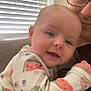 Aubrey is registered to the contest to win money with this photo: baby, infant, adult, glasses, window_blinds, pajamas, fruit_pattern, smile, face, closeup, indoor, couch, light, cozy, child, person, happy, arm, skin, warm