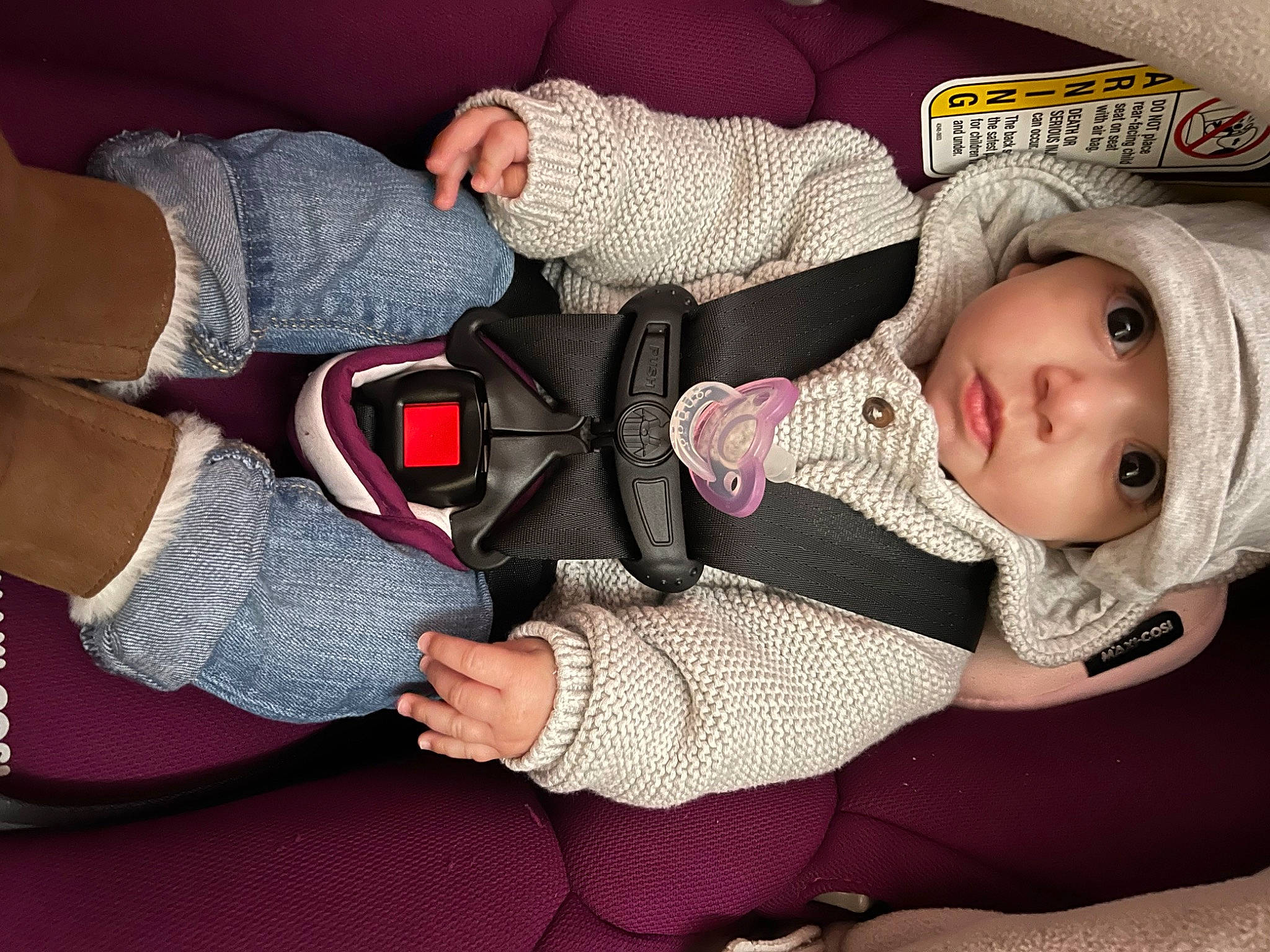 Flora is registered to the contest to win money with this photo: arm, baby, baby_products, baby_toddler_clothing, cheek, child, comfort, gesture, hand, headwear, human_body, knee, lap, leg, pattern, person, pink, sleeve, sock, textile