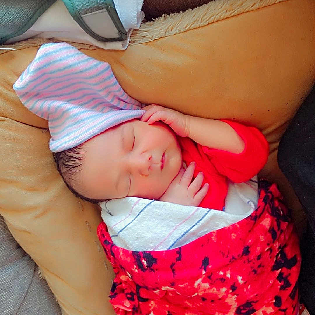 Vaelan Wayne joined the competition — help win amazing prizes! newborn, baby, sleeping, blanket, hat, couch, cushion, towel, indoors, resting, infant, person, cozy, soft, wrapped, cute, peaceful, child, home, relaxing