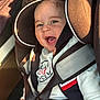 baby, car_seat, child, smiling, happy, seatbelt, clothing, infant, portrait, car_interior, sunlight, safety, cute, young_child, face, seat, joyful, casual_wear, closeup, daylight