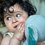 child, toddler, curly_hair, plush_toy, elephant_toy, close_up, face, hand, innocence, expression, soft_focus, person, cute, indoor, baby, holding, curiosity, skin, young_child, portrait