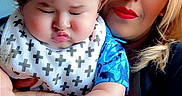 Jr joined the competition — help win amazing prizes! adult, baby, bib, blue_shirt, ceiling, child, cross_pattern, cuddling, face, family, hair, hands, indoor, portrait, pouting, selfie, serious_expression, woman, wooden_floor, 抱
