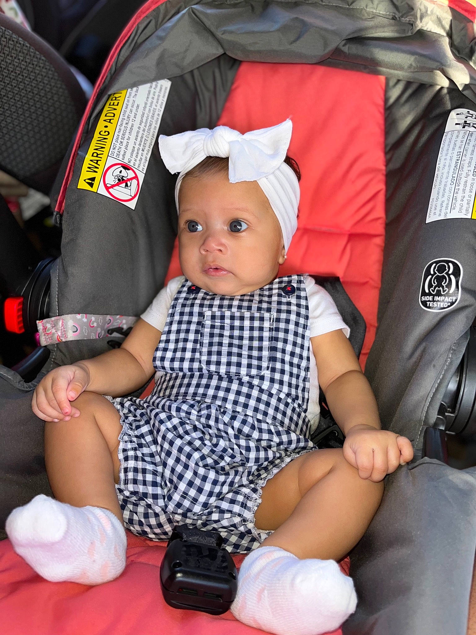 Jaliyah joined the competition — help win amazing prizes! baby, baby_carriage, baby_products, baby_toddler_clothing, black, cap, car_seat, child, comfort, fashion_accessory, fun, hat, headwear, lap, person, red, sitting, sleeve, sock, thigh