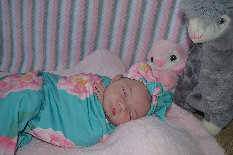 Liliana is registered to the contest to win money with this photo: baby, baby_products, baby_toddler_clothing, bedding, bedtime, cheek, child, comfort, couch, head, headwear, linens, pattern, person, pink, room, skin, stuffed_toy, teddy_bear, textile