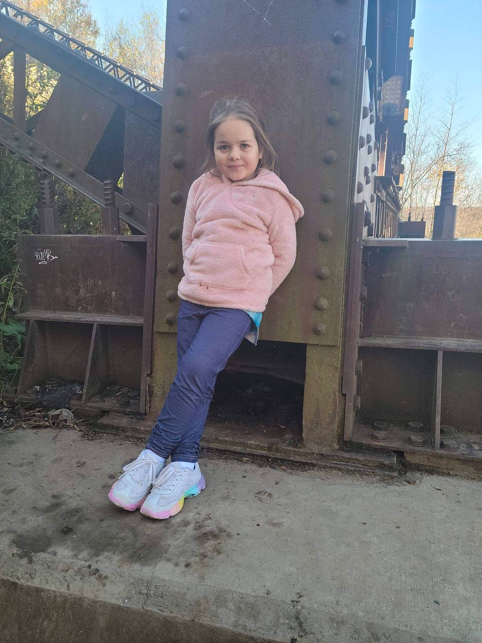 Ashtyn is registered to the contest to win money with this photo: child, city, denim, electric_blue, fun, grass, happy, human_leg, joy, leisure, magenta, person, plant, recreation, sitting, sky, sleeve, smile, t_shirt, toddler