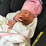 baby, newborn, sleeping, pacifier, pink_hat, blanket, car_seat, infant, cute, child, peaceful, soft, clothing, resting, indoors, baby_clothes, headwear, sleep, small_hands, comfort