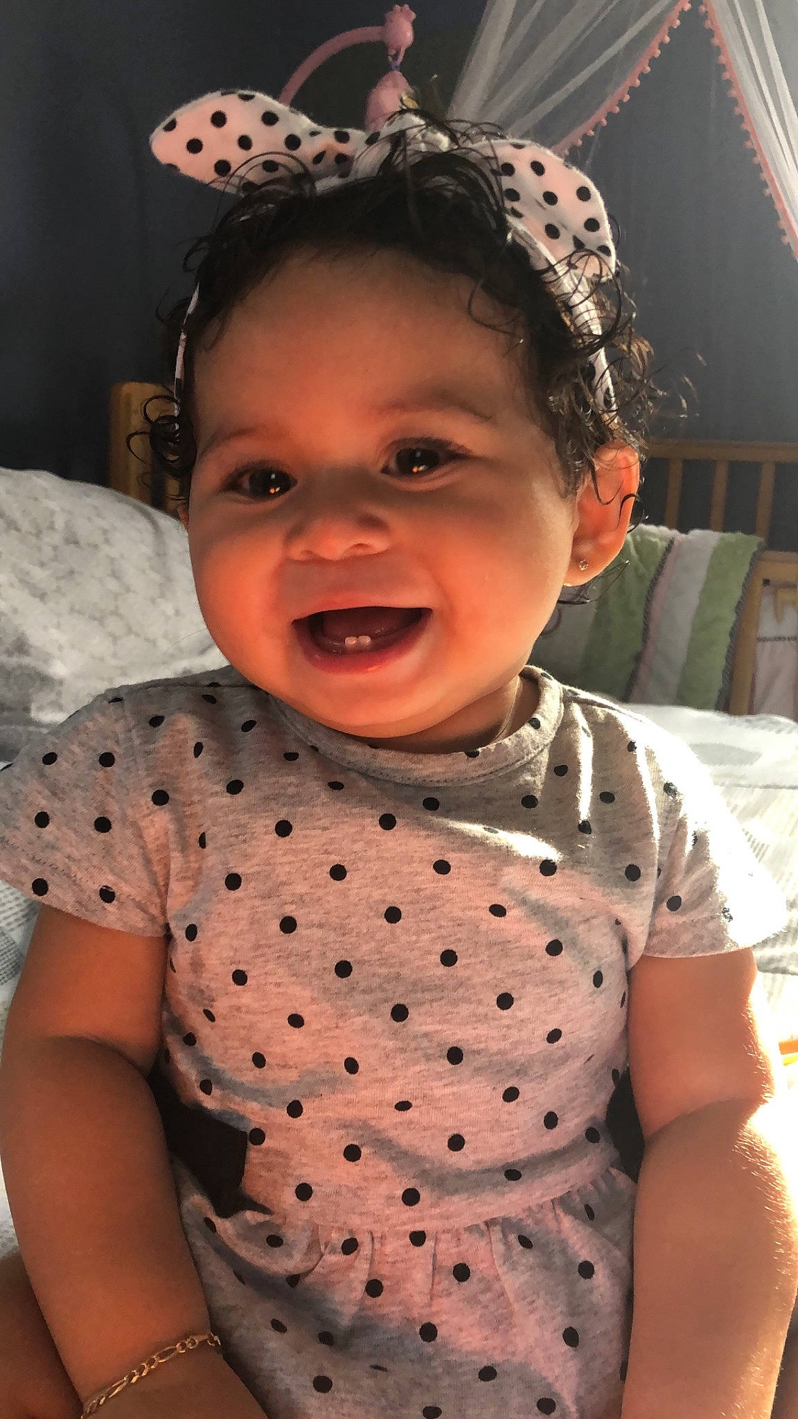 Alexandra is registered to the contest to win money with this photo: baby, baby_toddler_clothing, cheek, child, design, ear, face, fashion_accessory, forehead, hair_accessory, head, headgear, neck, nose, pattern, person, polka_dot, skin, smile, toddler