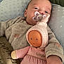 baby, bed, blanket, child, comfort, cozy, cute, doll, face, hand, indoors, infant, lying_down, pacifier, pillow, pink, plush, resting, sleepwear, soft_toy