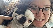 Dolly Polly Parton joined the competition — help win amazing prizes! girl, person, puppy, dog, black_and_white, selfie, smiling, glasses, curly_hair, sweatshirt, cuddling, pet, indoor, window, backlighting, portrait, closeup, happy, animal, casual