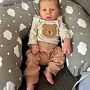 Clay is registered to the contest to win money with this photo: baby, infant, child, cushion, cloud_pattern, bear_design, clothing, pants, long_sleeve, barefoot, indoor, sofa, comfort, cute, portrait, person, small_hands, small_feet, relaxing, cozy