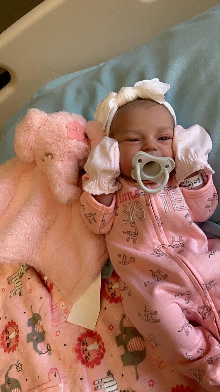 Everly is registered to the contest to win money with this photo: baby, baby_toddler_clothing, cheek, eye, eyelash, face, hand, happy, head, human_body, lip, mammal, mouth, nose, person, pink, product, skin, textile, toddler