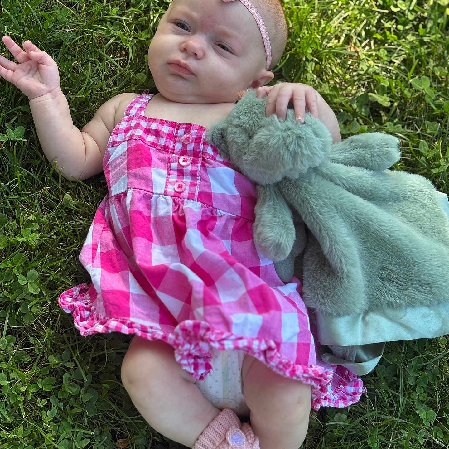 Octavia joined the competition — help win amazing prizes! baby, child, cute, expression, footwear, grass, greenery, hand, headband, infant, knitted_slippers, lying_down, nature, outdoor, pink_dress, plush_toy, relaxing, soft_toy, summer, unicorn