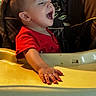 Kobe is registered to the contest to win money with this photo: baby, child, infant, high_chair, laughing, smiling, portrait, indoor, home, red_shirt, seated, feeding_tray, hand, face, short_hair, warm_lighting, furniture, baby_product, happy, photograph