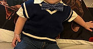 Kobe joined the competition — help win amazing prizes! child, toddler, smiling, portrait, indoor, sitting, bed, bedding, bow_tie, sweater_vest, shirt, jeans, boots, brown_hair, face, happy, baby, furniture, warm_lighting, home