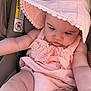 baby, infant, sun_hat, pink_outfit, car_seat, warning_label, seat, chubby_legs, baby_arms, face, eyelashes, looking_down, cute, adorable, pale_skin, closeup, portrait, ruffles, fabric, summer