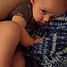 baby, child, infant, sleepy, cuddle, arm, foot, blue_clothing, pattern, skin, person, closeup, face, expression, resting, indoor, human, comfort, toddler, leg