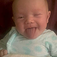 Aaliyah Smith is registered to the contest to win money with this photo: baby, infant, child, portrait, face, winking, tongue_out, smiling, happy, sitting, blanket, onesie, clothing, cozy, curtain, indoors, close_up, head, cute, photography
