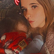 Danni is registered to the contest to win money with this photo: blanket, child, clothing, cozy, devil_horns, face, family, filter, hair, hand, holding, indoor, intimate, lip_piercing, neon, nose_ring, portrait, soft_focus, warm_tones, woman