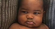 Kaysn Miller joined the competition — help win amazing prizes! baby, child, chubby, closeup, comfortable, couch, cushion, cute, diaper, expression, face, indoor, infant, person, portrait, rolls, sitting, skin, texture, young