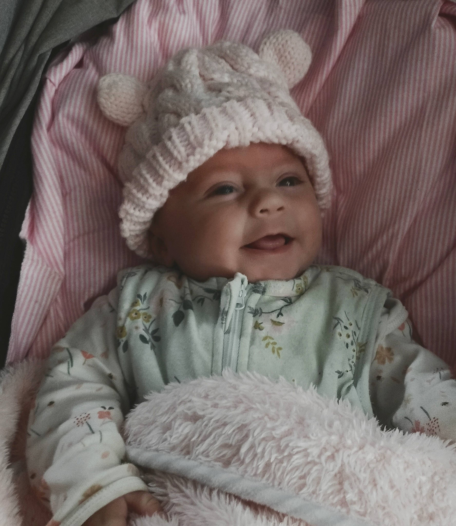 Denise is registered to the contest to win money with this photo: baby, bonnet, cheek, child, fur, headgear, headwear, knit_cap, knitting, person, skin, smile, toddler, wool