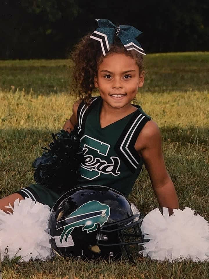 Chasity joined the competition — help win amazing prizes! american_football, cheerleading, child, grass, hair_accessory, joy, person, sports_uniform, team_sport, toddler, uniform