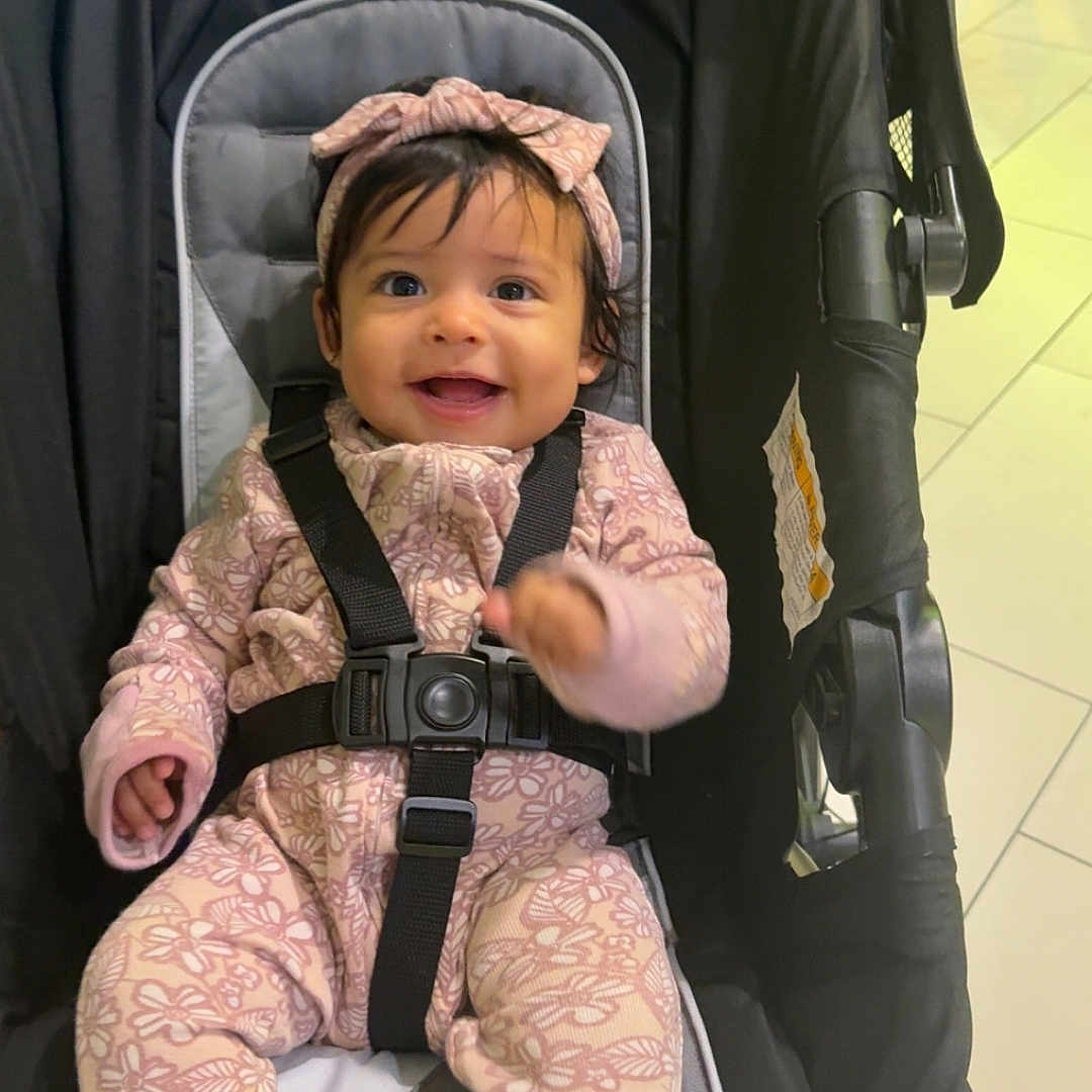 Alitzel joined the competition — help win amazing prizes! baby, babywear, black, child, childcare, clothing, cute, floor, happy, headband, indoor, infant, onesie, person, pink, portrait, seatbelt, sitting, smiling, stroller